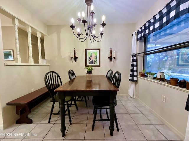 dining space featuring light tile patterned floors and a chandelier