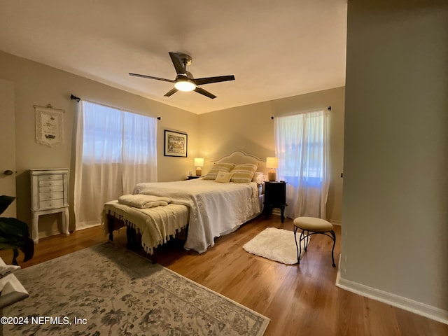 bedroom with hardwood / wood-style flooring and ceiling fan