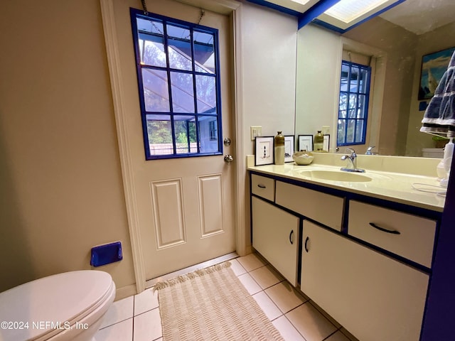 bathroom featuring tile patterned floors, vanity, and toilet