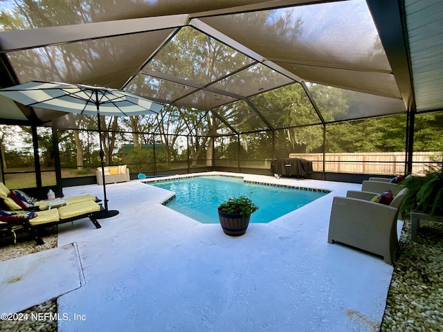 view of swimming pool with a lanai and a patio