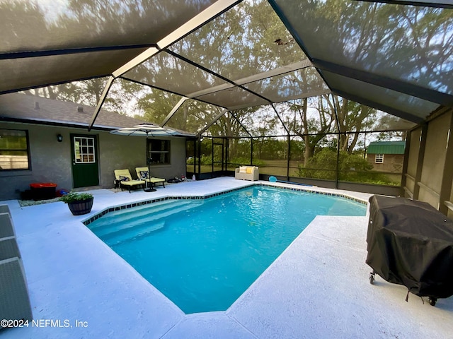 view of pool featuring a lanai, a patio, and grilling area