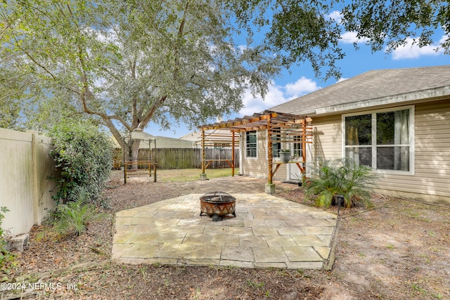 view of patio / terrace featuring a pergola and a fire pit