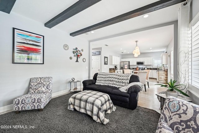 living room with beamed ceiling and wood-type flooring