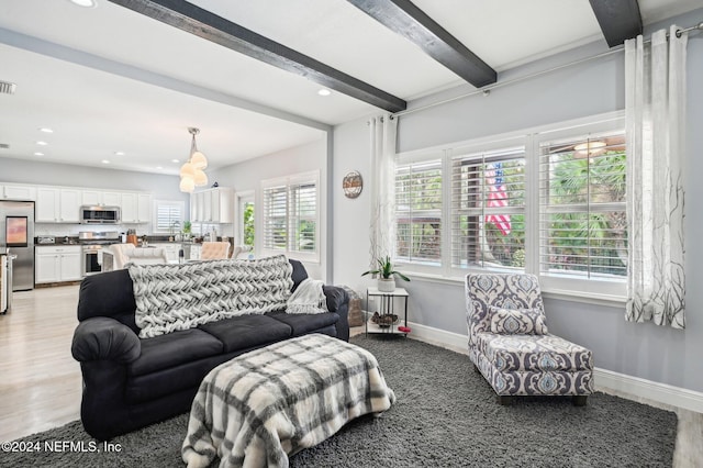 living room with beam ceiling and light hardwood / wood-style flooring