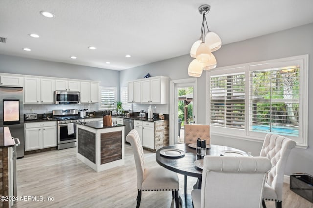 dining space with light hardwood / wood-style flooring