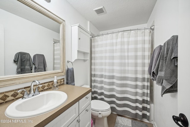 bathroom with walk in shower, tile patterned flooring, a textured ceiling, toilet, and vanity