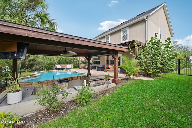 view of swimming pool featuring a lawn, a patio area, ceiling fan, and an outdoor hangout area