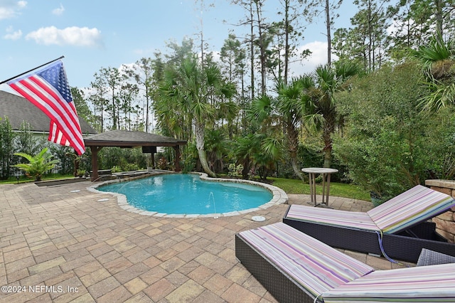 view of swimming pool with a gazebo and a patio area