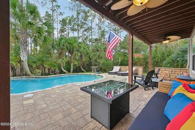 view of pool with pool water feature, an outdoor living space, ceiling fan, and a patio