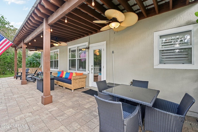 view of patio with an outdoor living space and ceiling fan