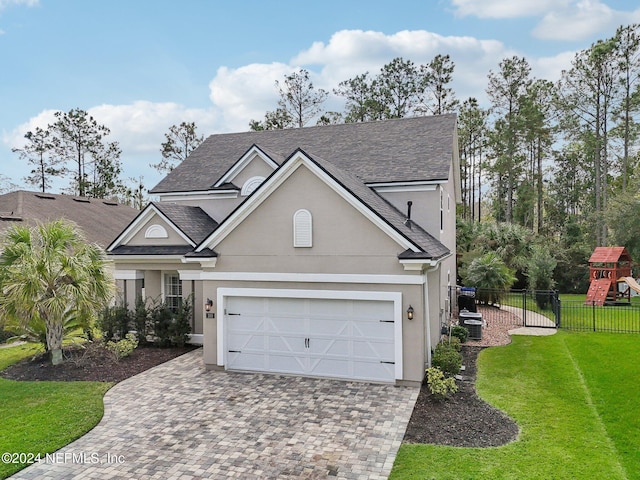 view of front of property with a garage and a front yard