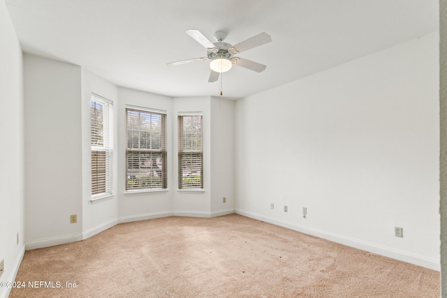 carpeted empty room featuring ceiling fan