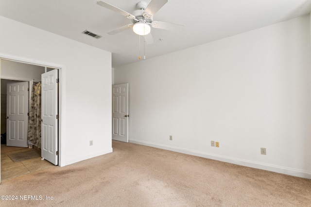 unfurnished bedroom with ceiling fan and light colored carpet