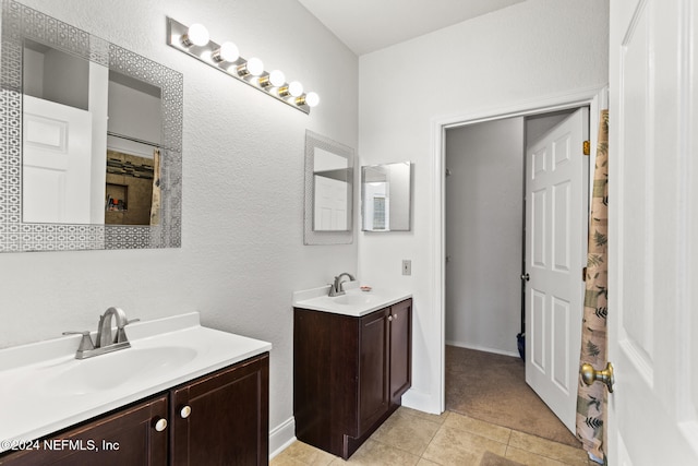 bathroom featuring tile patterned flooring and vanity