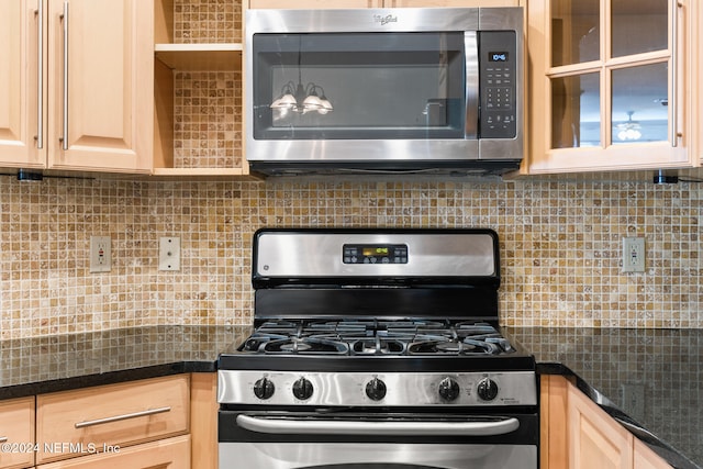 kitchen with light brown cabinets, stainless steel appliances, and tasteful backsplash