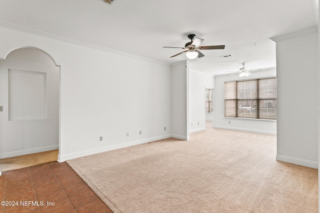 unfurnished living room featuring dark colored carpet, ceiling fan, and crown molding