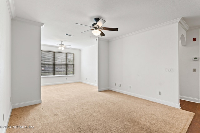 empty room featuring ceiling fan, ornamental molding, and carpet floors