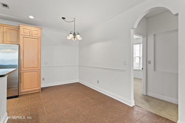 kitchen featuring light brown cabinets, an inviting chandelier, stainless steel refrigerator, and ornamental molding