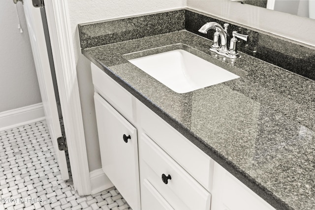 bathroom with tile patterned flooring and vanity