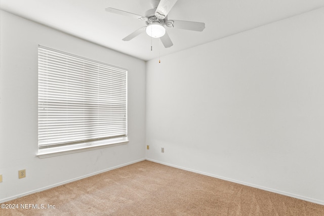 carpeted empty room featuring ceiling fan