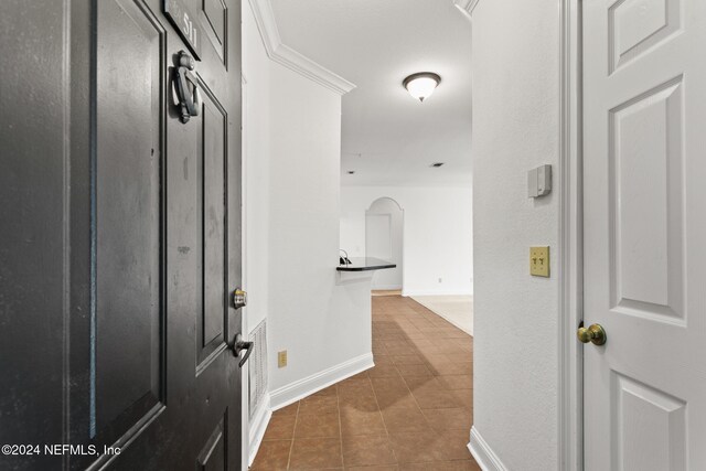 hallway featuring dark tile patterned floors