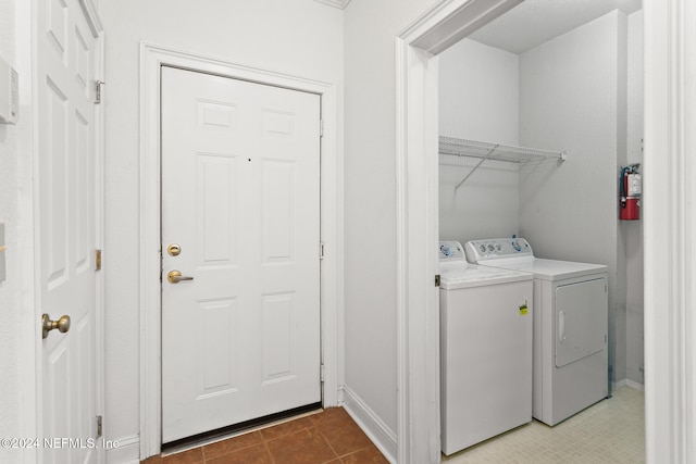 washroom featuring light tile patterned floors and washing machine and clothes dryer