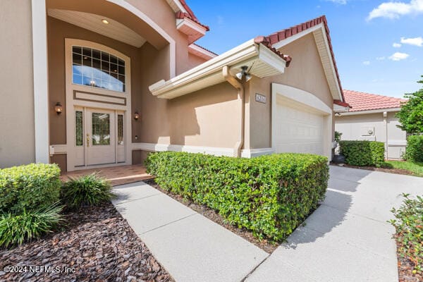 view of exterior entry featuring a garage