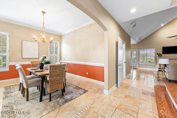 dining space with crown molding, lofted ceiling, and an inviting chandelier