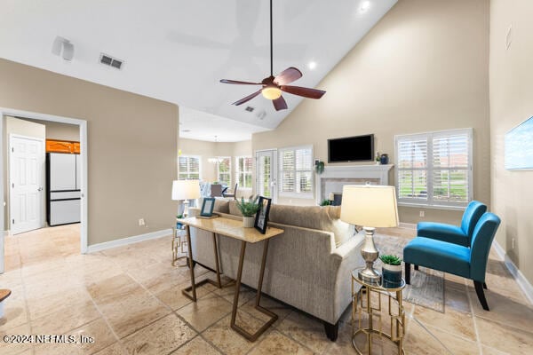 living room featuring high vaulted ceiling and ceiling fan