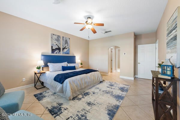 tiled bedroom with ceiling fan