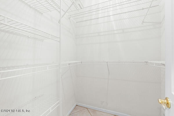 spacious closet featuring light tile patterned floors