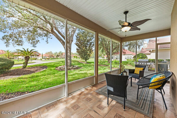 sunroom / solarium featuring ceiling fan