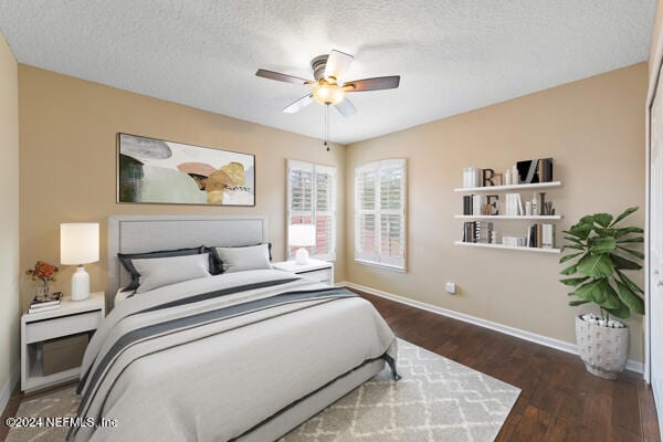 bedroom featuring ceiling fan, dark hardwood / wood-style flooring, and a textured ceiling