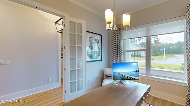 office featuring a notable chandelier, plenty of natural light, and wood finished floors