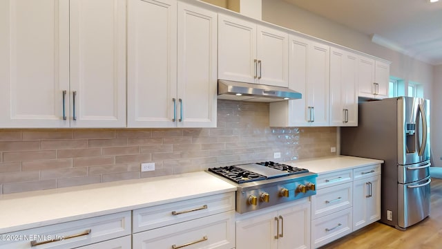 kitchen featuring under cabinet range hood, white cabinetry, stainless steel appliances, and light countertops