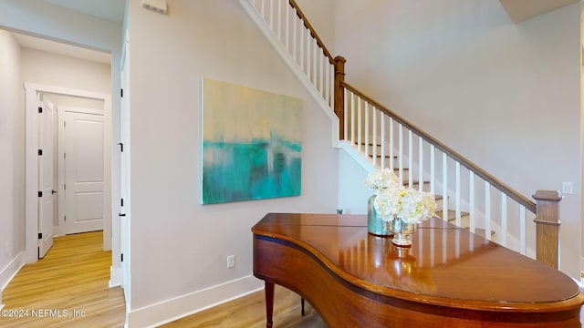 dining space with stairway, wood finished floors, and baseboards