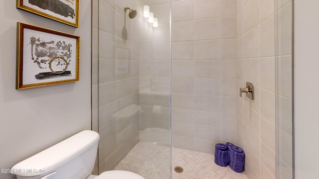 full bath featuring toilet and a tile shower