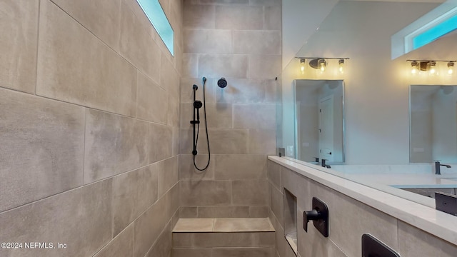 full bathroom with double vanity and tiled shower