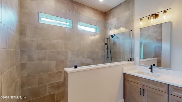 bathroom featuring walk in shower and vanity