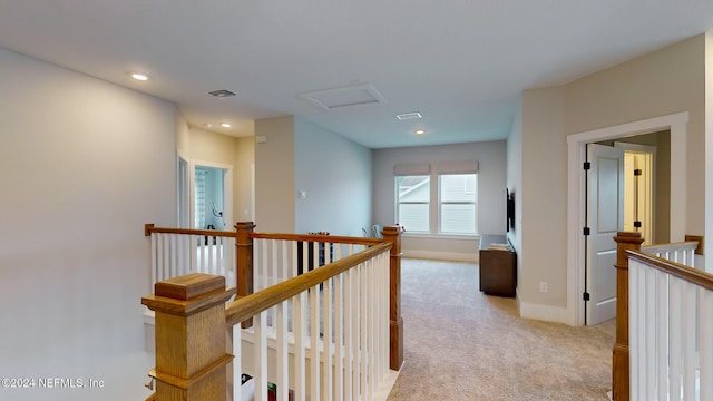 corridor featuring attic access, visible vents, light colored carpet, an upstairs landing, and recessed lighting