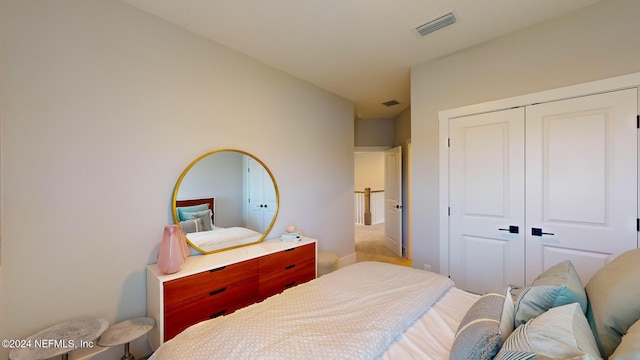 bedroom with a closet and visible vents