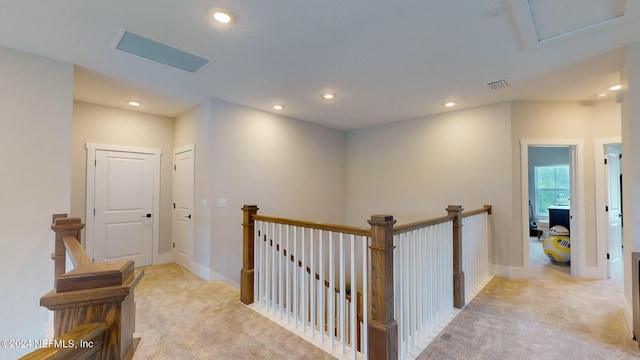 corridor featuring light carpet, visible vents, baseboards, an upstairs landing, and recessed lighting