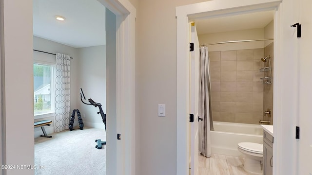 bathroom featuring shower / bath combination with curtain and toilet