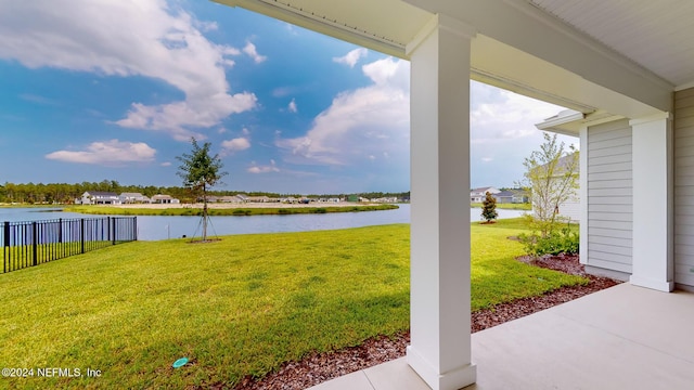 view of yard featuring a water view and fence