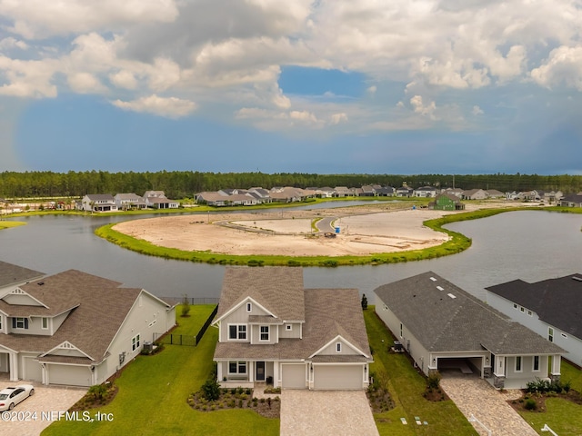 drone / aerial view featuring a residential view and a water view