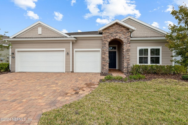 view of front of house with a garage and a front yard