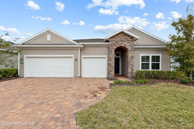 view of front of house featuring a garage and a front lawn