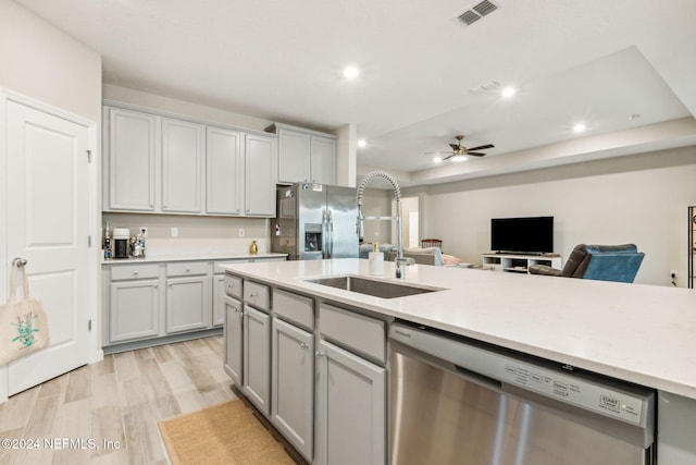 kitchen featuring light hardwood / wood-style floors, sink, gray cabinets, ceiling fan, and appliances with stainless steel finishes