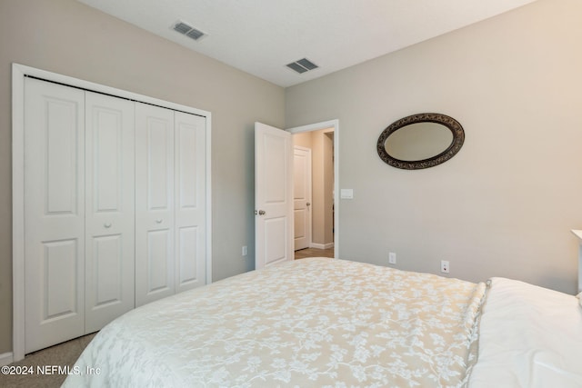 bedroom featuring carpet and a closet