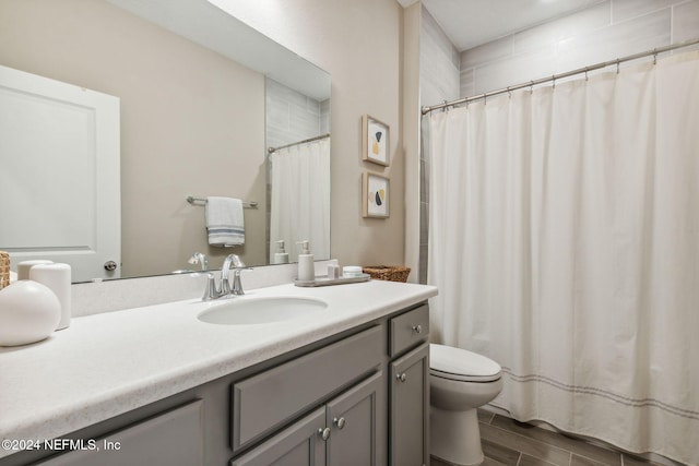 bathroom featuring vanity, hardwood / wood-style flooring, and toilet